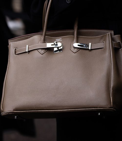 Paris, France - January, 25, 2024: woman wears Hermes Birkin handbag, street style details